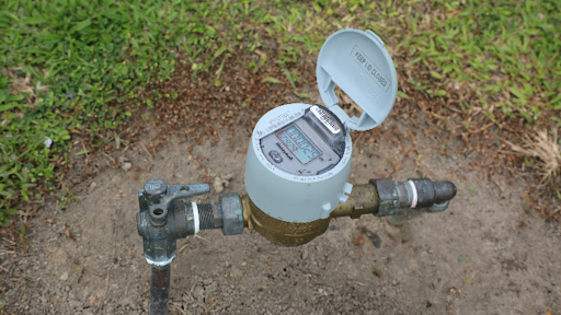 Solar-powered stormwater control equipment monitoring water levels in a natural basin